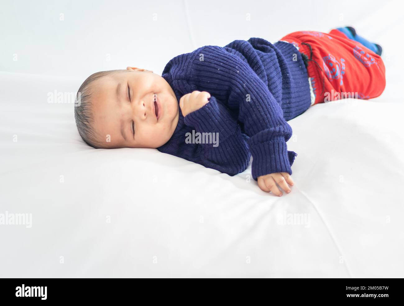 infant boy lying cute facial expression with white background at indoor Stock Photo