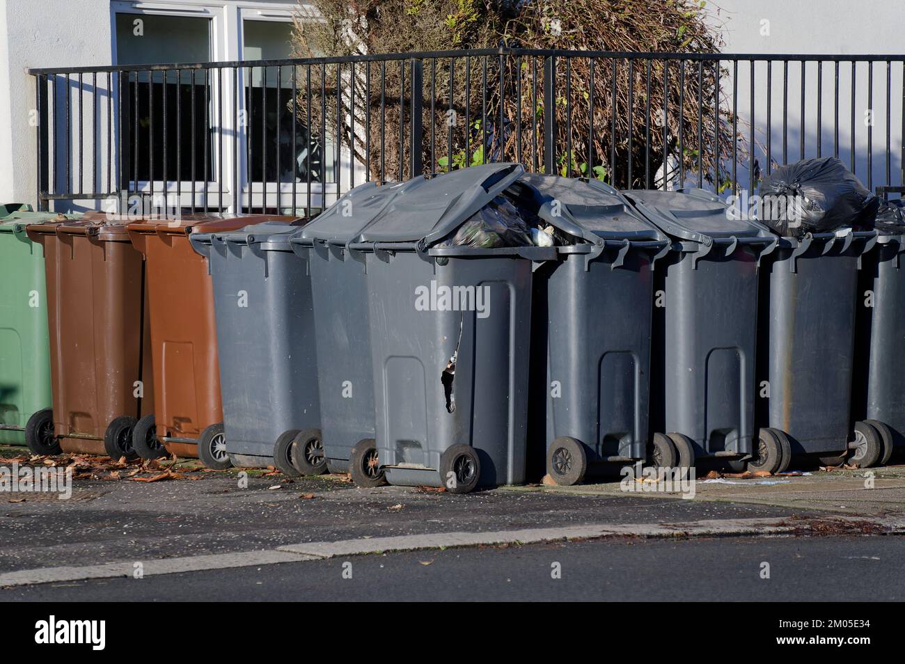 Wheelie bins in row for refuge collection outside council residential