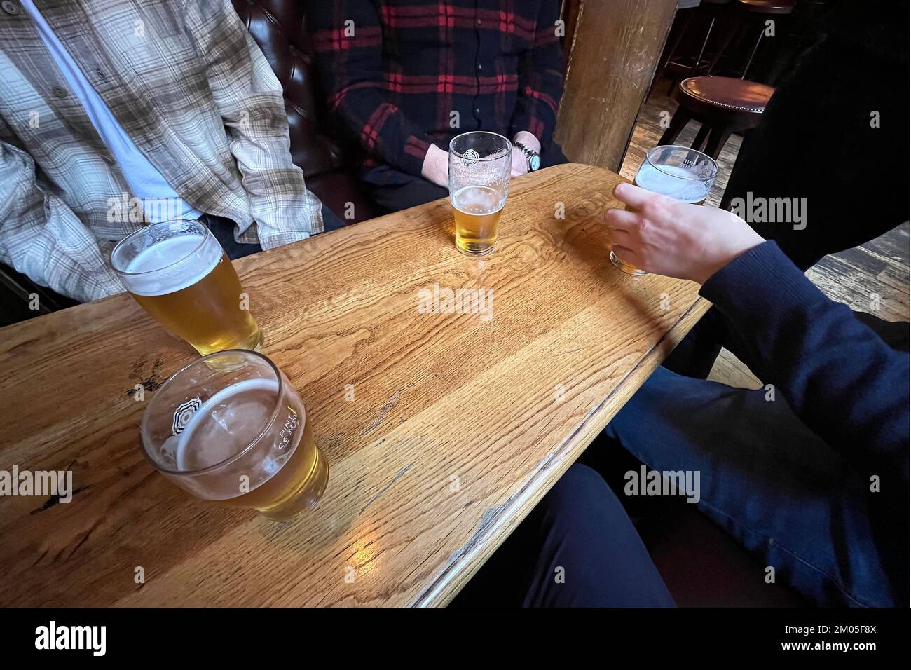 Drinking beers in a London pub. December 2022. Stock Photo