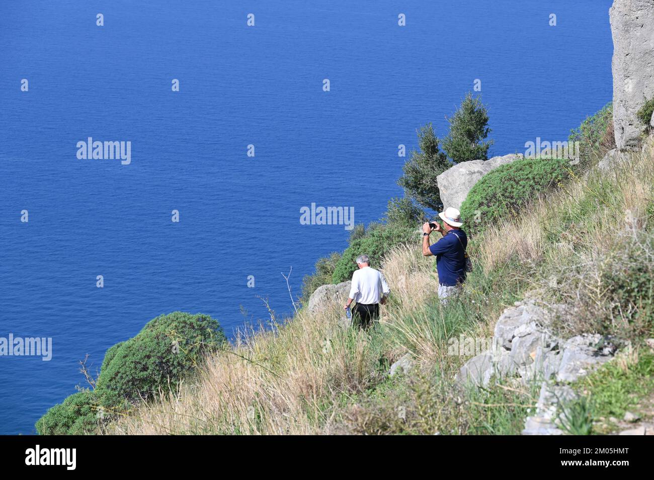 Tourists at the rock di Cefalu in Italy Stock Photo