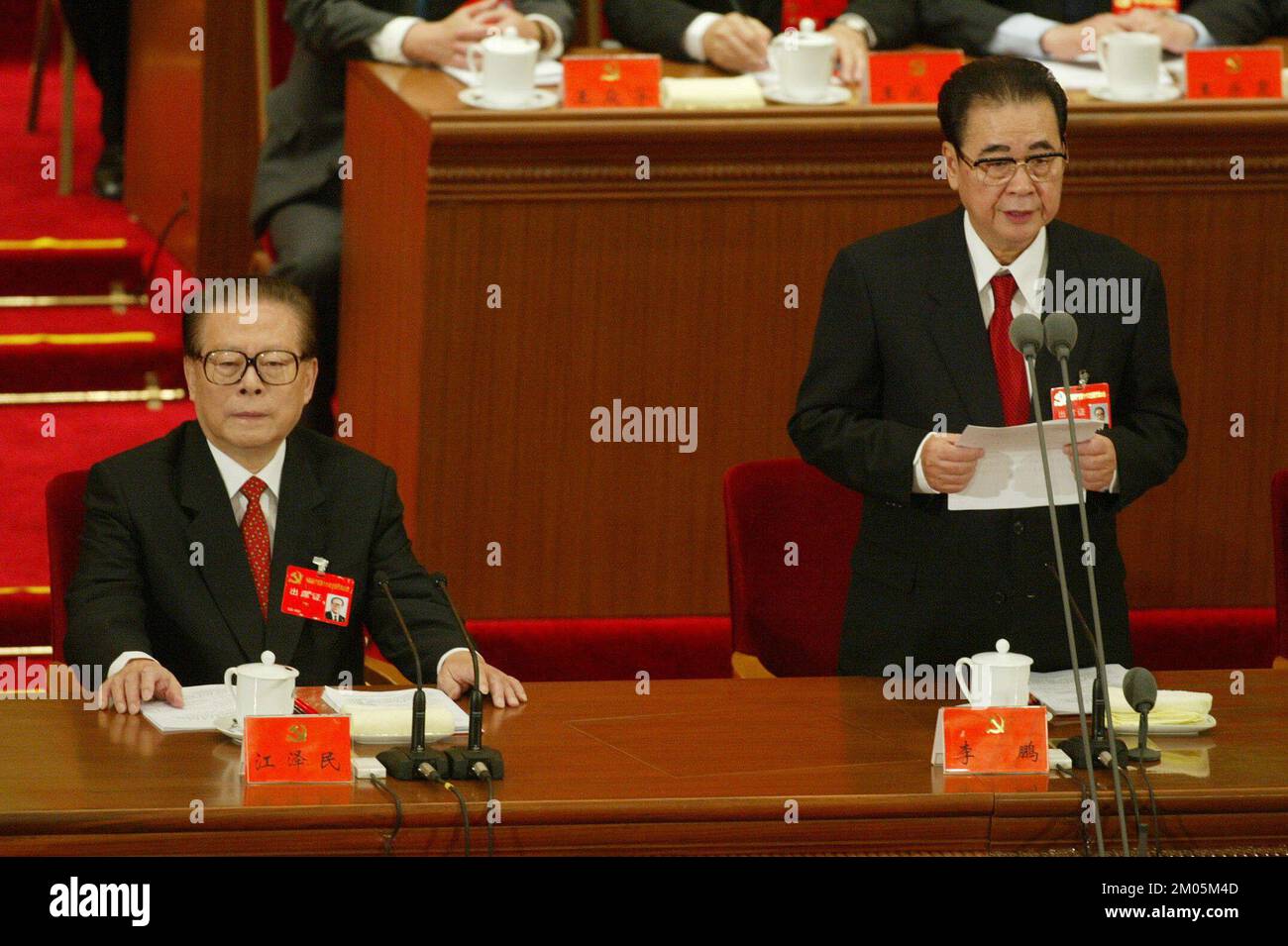 The Chinese President Jiang Zemin (L) listens as Chairman of the National People's Congress Mr Li Peng delivers a  speech on the opening day of the China's 16th Communist Party Congress at the Great Hall of the People in Beijing, China. 08 November 2002  ***NOT FOR ADVERTISING USE*** Stock Photo