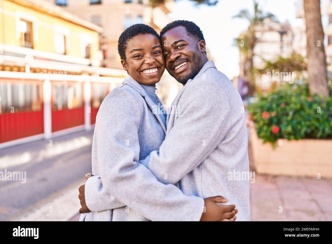 Man and woman couple hugging each other standing at street Stock Photo ...