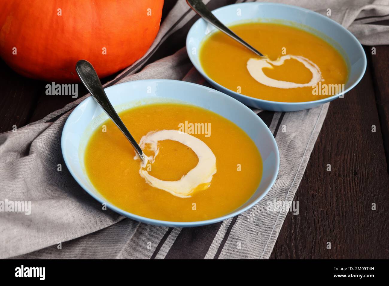 Freshness soup with pumpkin for autumn dinner on rustic table . Stock Photo