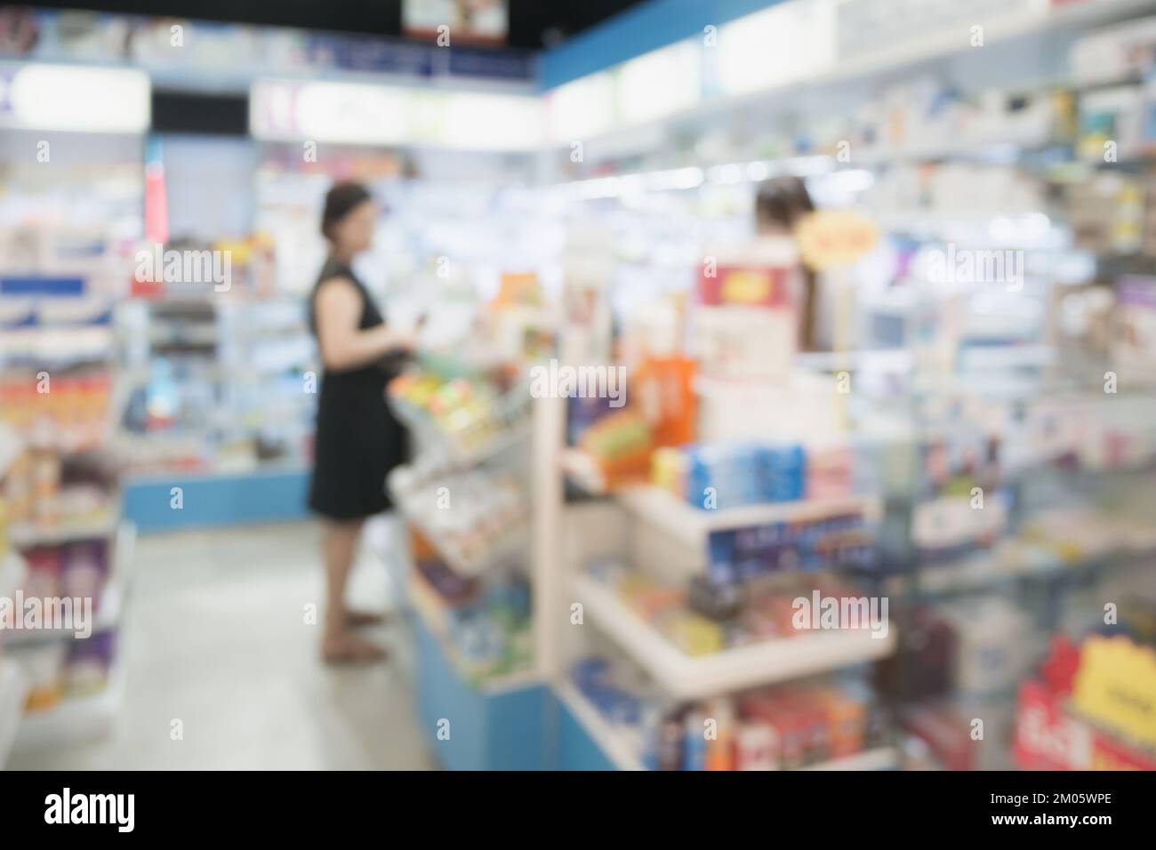customer in pharmacy drugstore shop interior with medicines vitamins