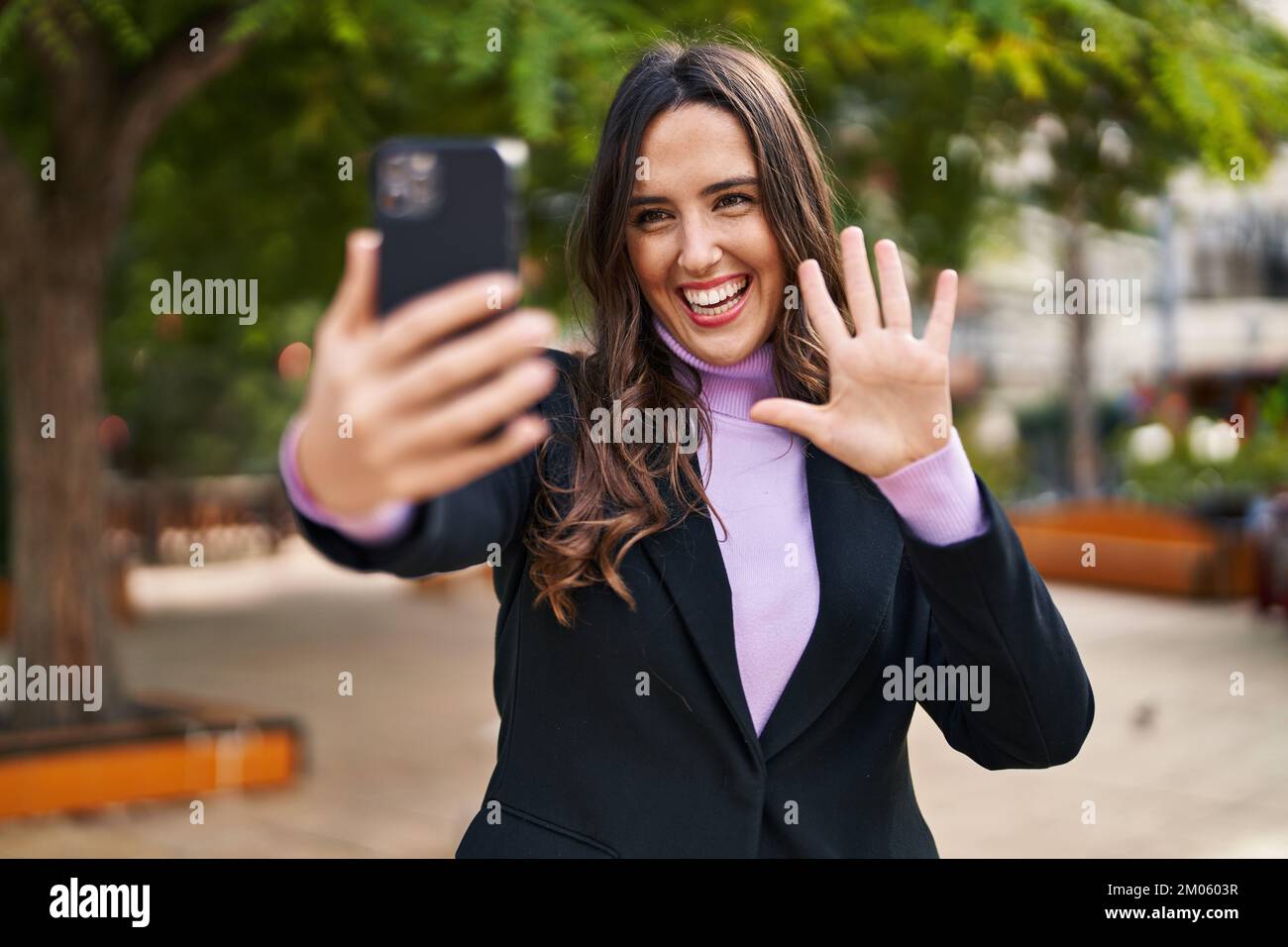 Young hispanic woman smiling confident having video call at park Stock ...