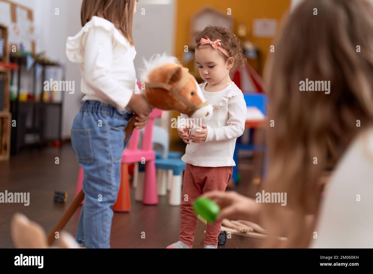 Two little girls playing with toys at kindergarten Stock Photo - Alamy