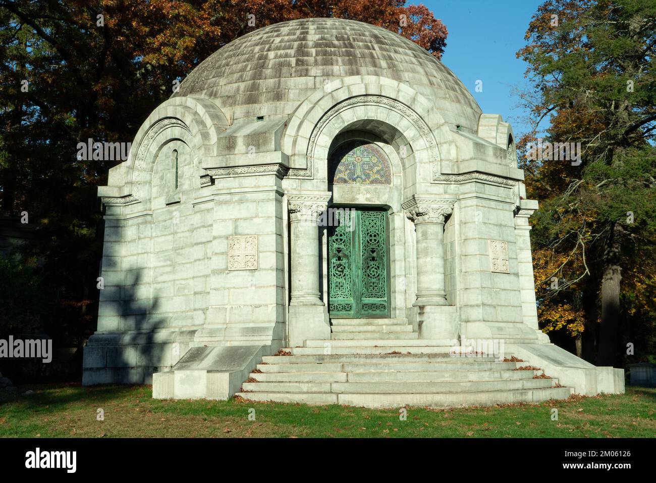 Cemetery round mausoleum with dome and green iron gate in Sleepy Hollow cemetery, New York. Stock Photo