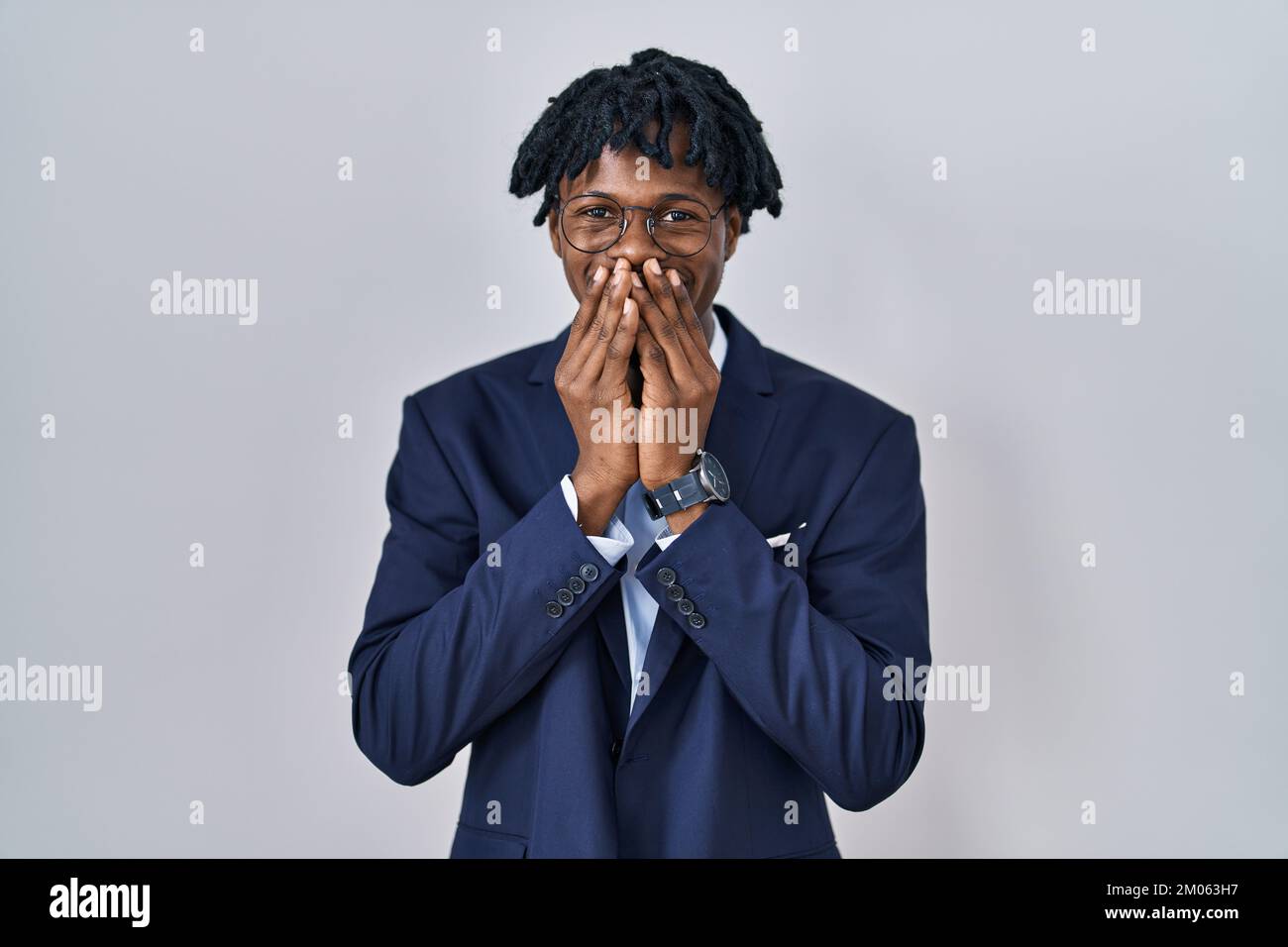 Young african man with dreadlocks wearing business jacket over white ...