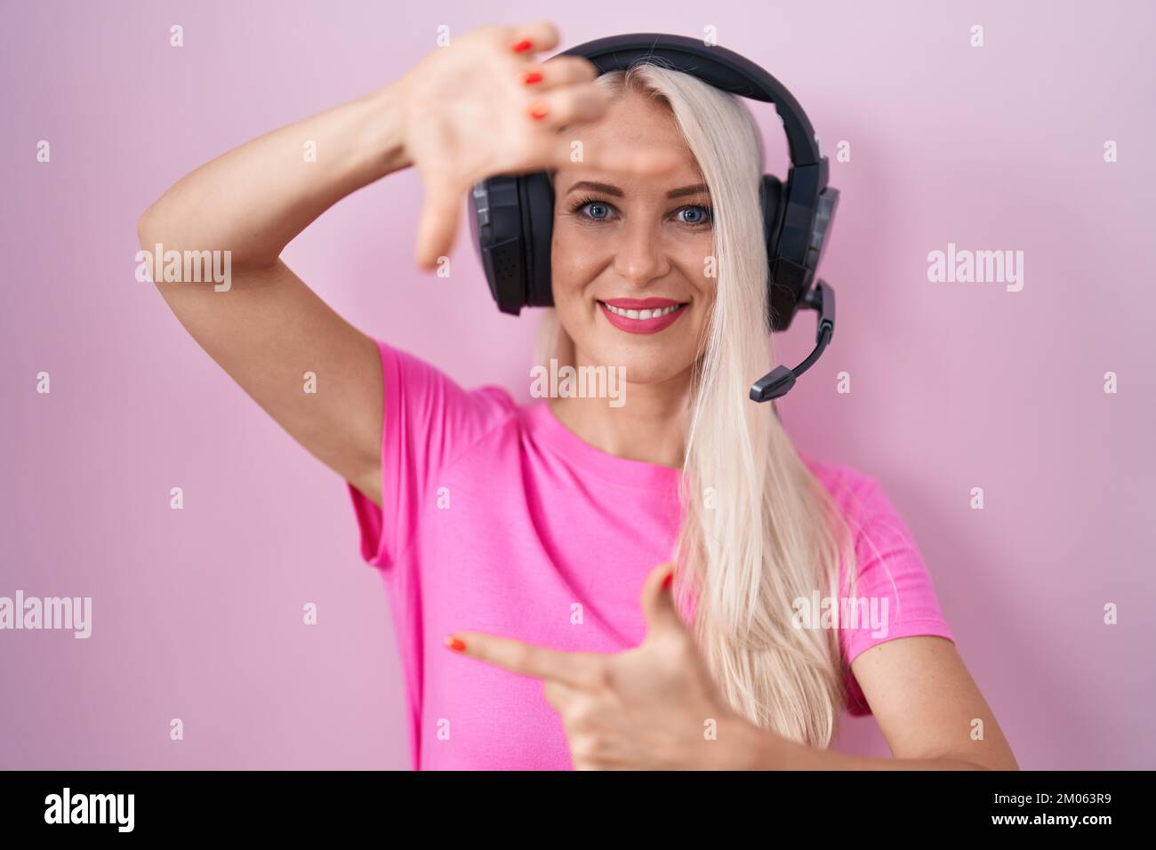 Caucasian woman listening to music using headphones smiling making ...