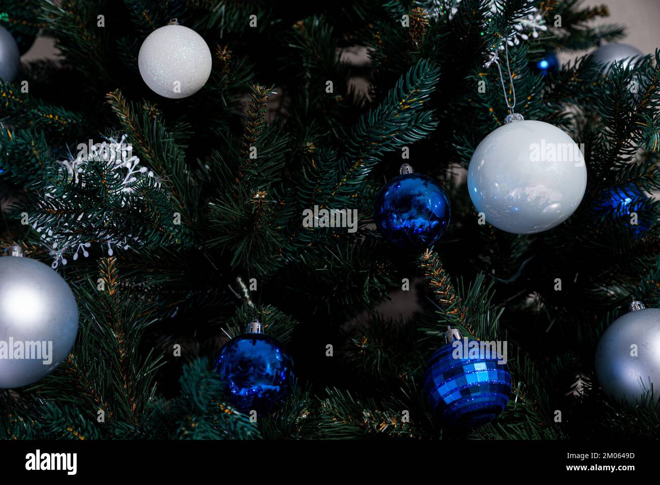 christmas tree with colorful balls and gift boxes over white brick wall ...