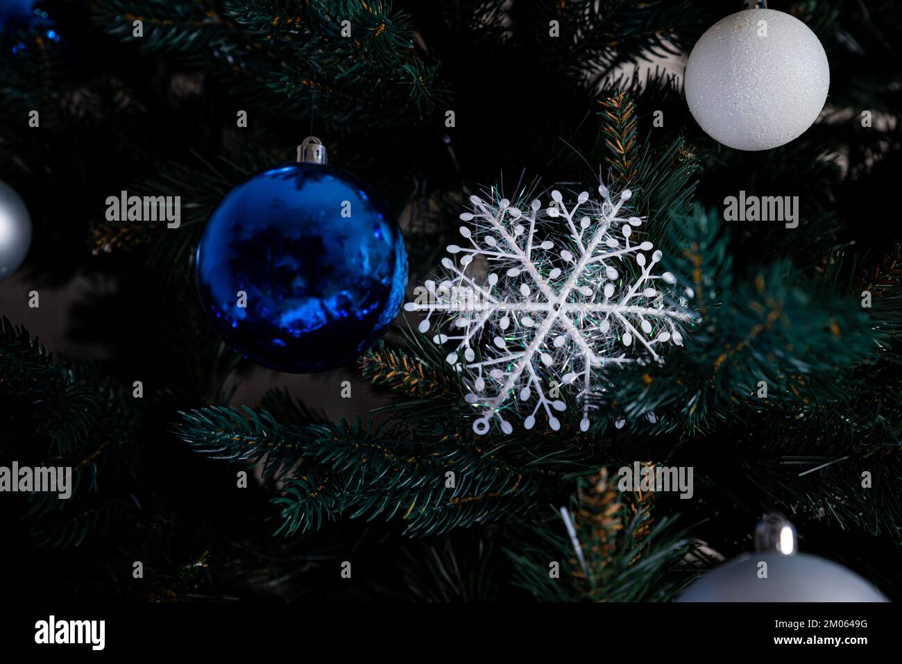 christmas tree with colorful balls and gift boxes over white brick wall ...