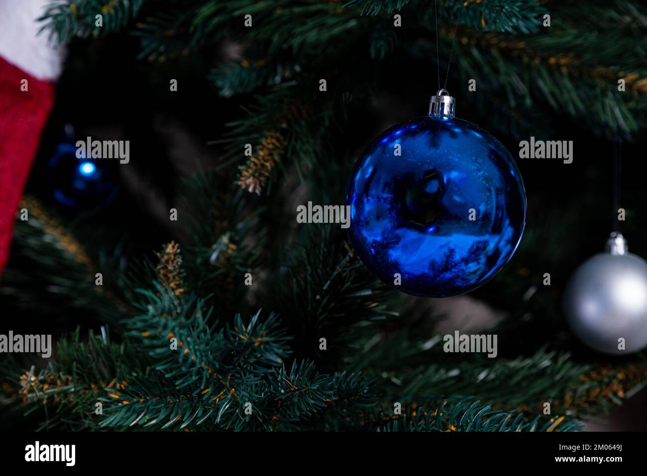 christmas tree with colorful balls and gift boxes over white brick wall ...