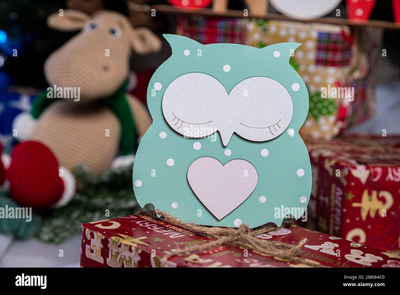 Wooden toys for the Christmas tree and green branches of the Christmas