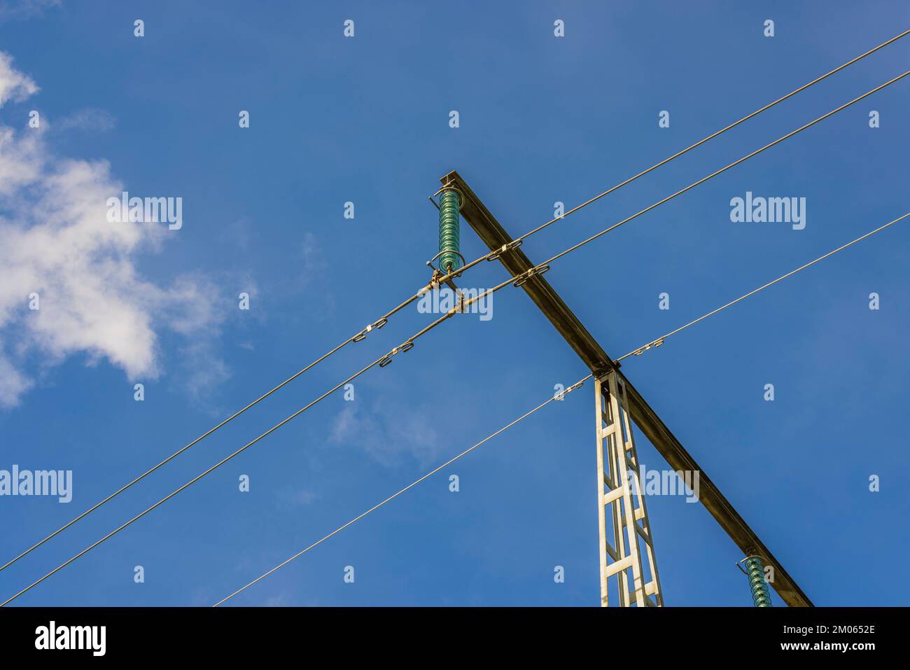 View of highvoltage electric power transmission line on blue sky