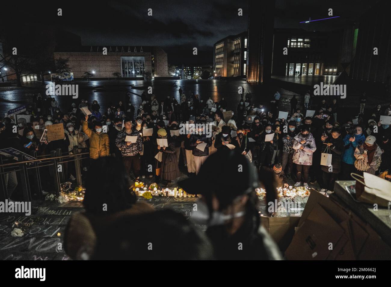 Protesters hold blank papers and lit candles during the demonstration ...