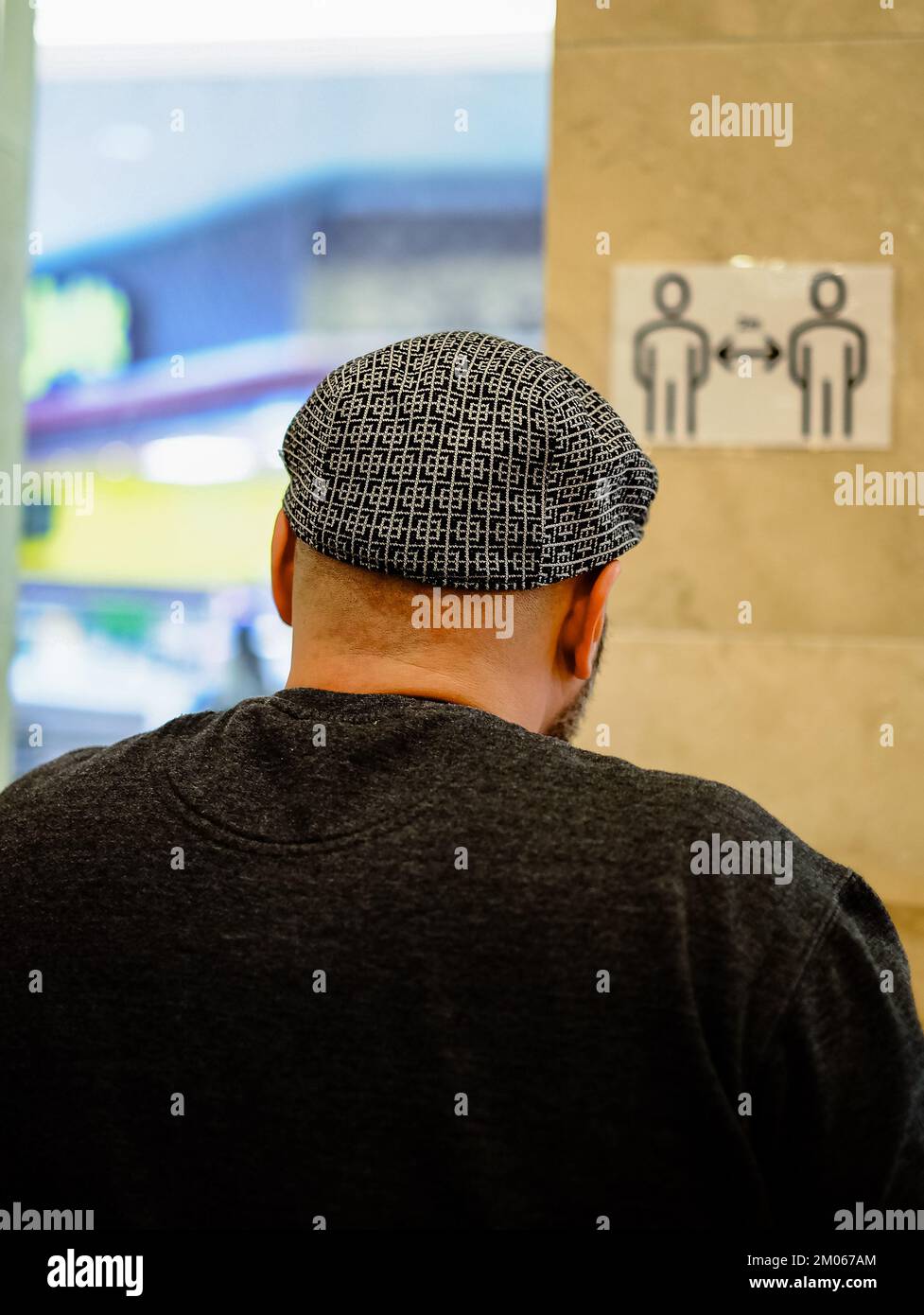 Adult man bald head rear back view. Human alopecia or hair loss. Selective focus, street photo. Man bald head wearing a hat Stock Photo
