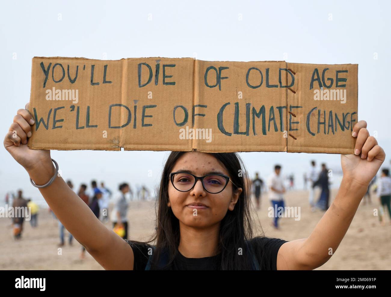 Mumbai, India. 04th Dec, 2022. A volunteer poses for a photo while holding a placard at Juhu beach to create awareness about climate change in Mumbai. Fridays For Future (FFF) is a movement for climate justice in a peaceful non violent way by creating awareness about the environment and urging the government to address the climate crisis and ecological damage. (Photo by Ashish Vaishnav/SOPA Images/Sipa USA) Credit: Sipa USA/Alamy Live News Stock Photo