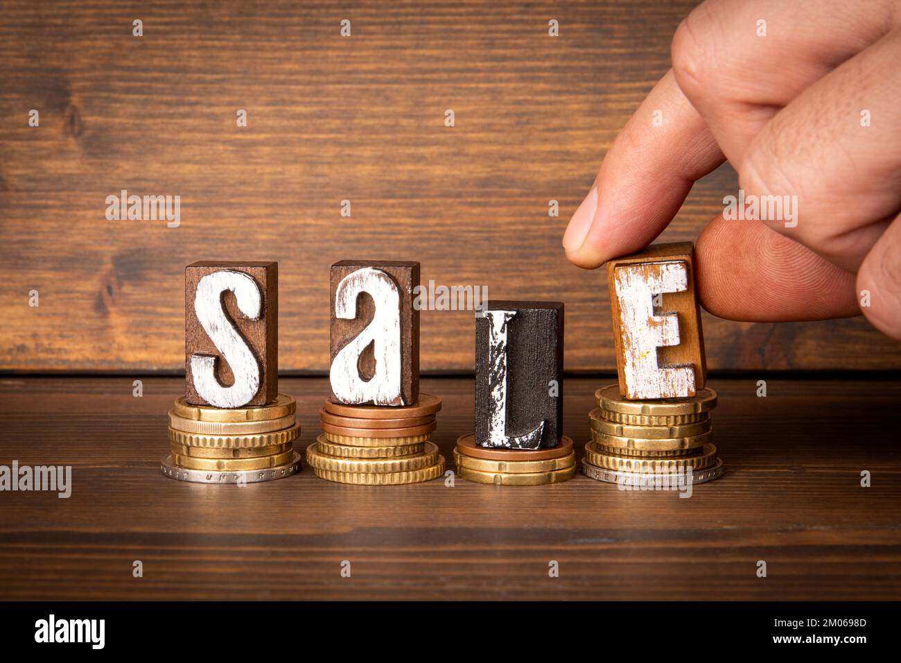 SALE, Business Concept. Change and wooden alphabet letters. Stock Photo
