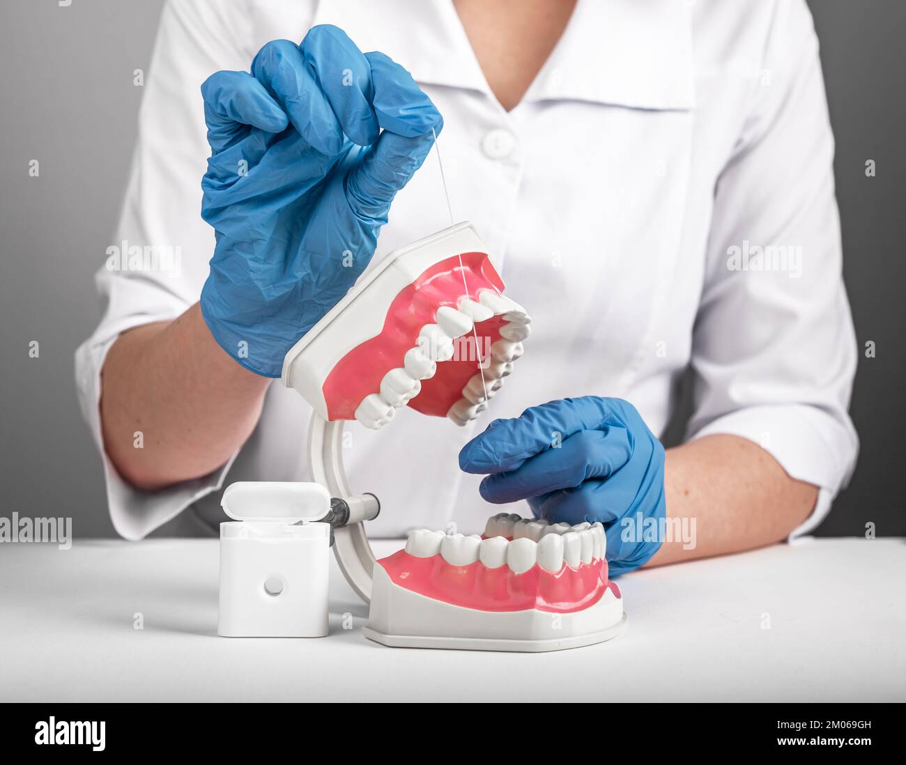 Cleaning teeth gaps with dental floss, tooth care, treatment. Oral dental hygiene shown by