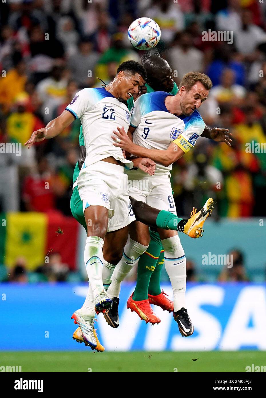 Senegal's Kalidou Koulibaly battles for possession of the ball in the air with England's Jude Bellingham, (left) and Harry Kane (right) during the FIFA World Cup Round of Sixteen match at the Al-Bayt Stadium in Al Khor, Qatar. Picture date: Sunday December 4, 2022. Stock Photo