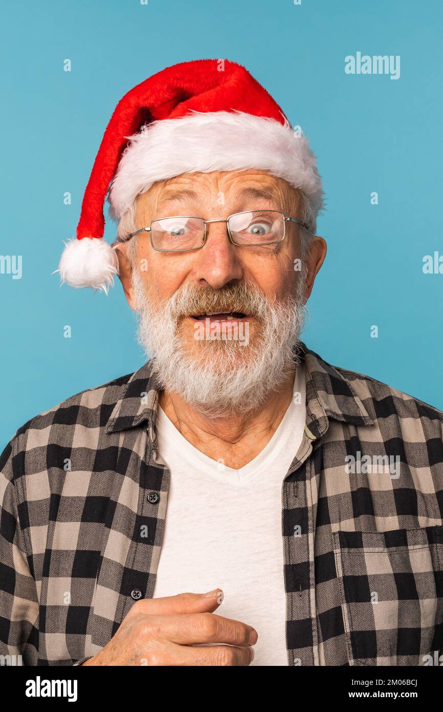 https://c8.alamy.com/comp/2M06BCJ/portrait-of-shocked-old-man-wear-santa-christmas-hat-open-mouth-isolated-on-blue-color-background-elderly-people-and-emotion-concept-2M06BCJ.jpg