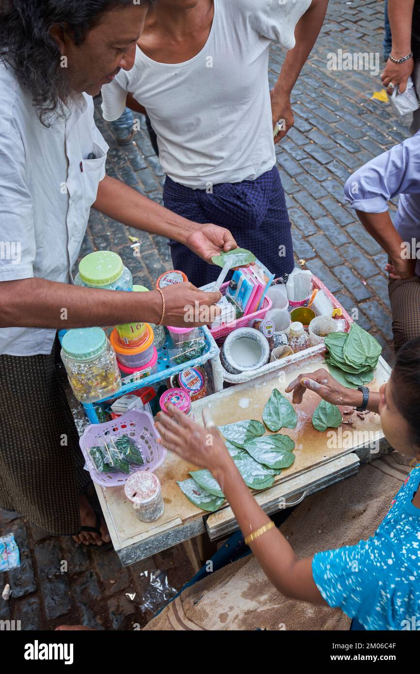 Kun-ya Vendor in Yangon Myanmar - also known as Paan - Chewing betel leaves with areca nuts and slaked lime paste is popular with locals Stock Photo