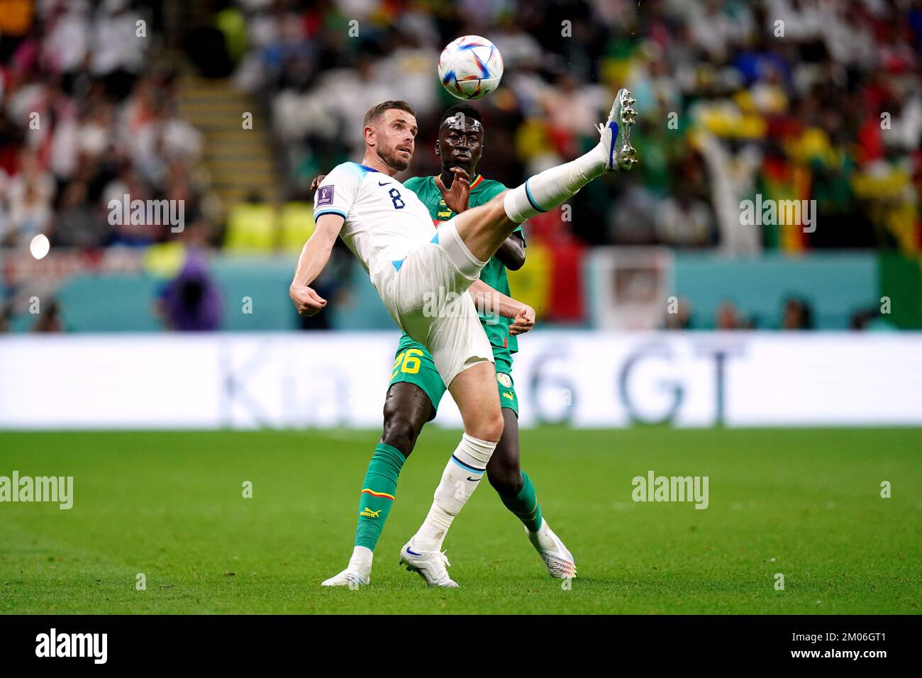 Senegal's Pape Gueye battles for possession of the ball with England's Jordan Henderson during the FIFA World Cup Round of Sixteen match at the Al-Bayt Stadium in Al Khor, Qatar. Picture date: Sunday December 4, 2022. Stock Photo