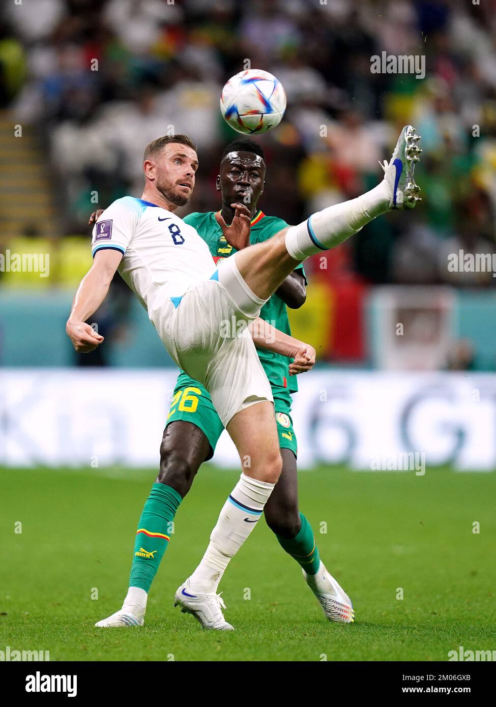 England's Jordan Henderson battles for possession of the ball with Senegal's Pape Gueye during the FIFA World Cup Round of Sixteen match at the Al-Bayt Stadium in Al Khor, Qatar. Picture date: Sunday December 4, 2022. Stock Photo