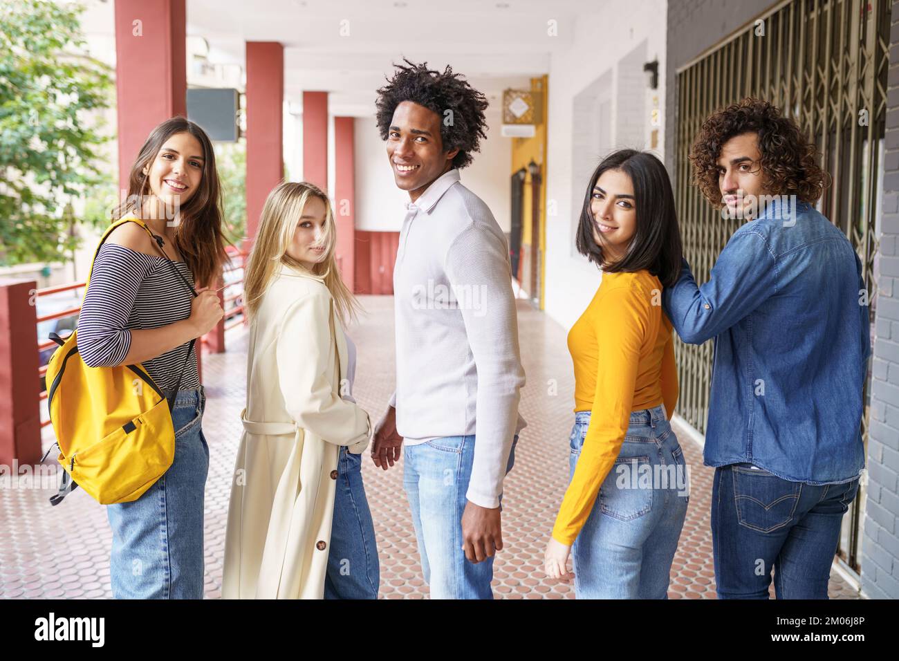 Group of beautiful friends of different ethnic having fun together in the street. Stock Photo