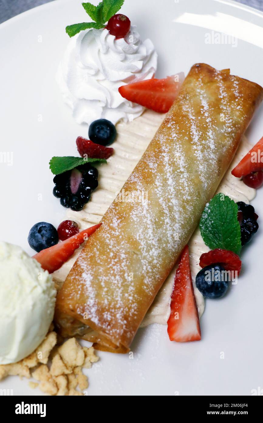 traditional apple strudel with whiped cream and assorted mix berries Stock Photo