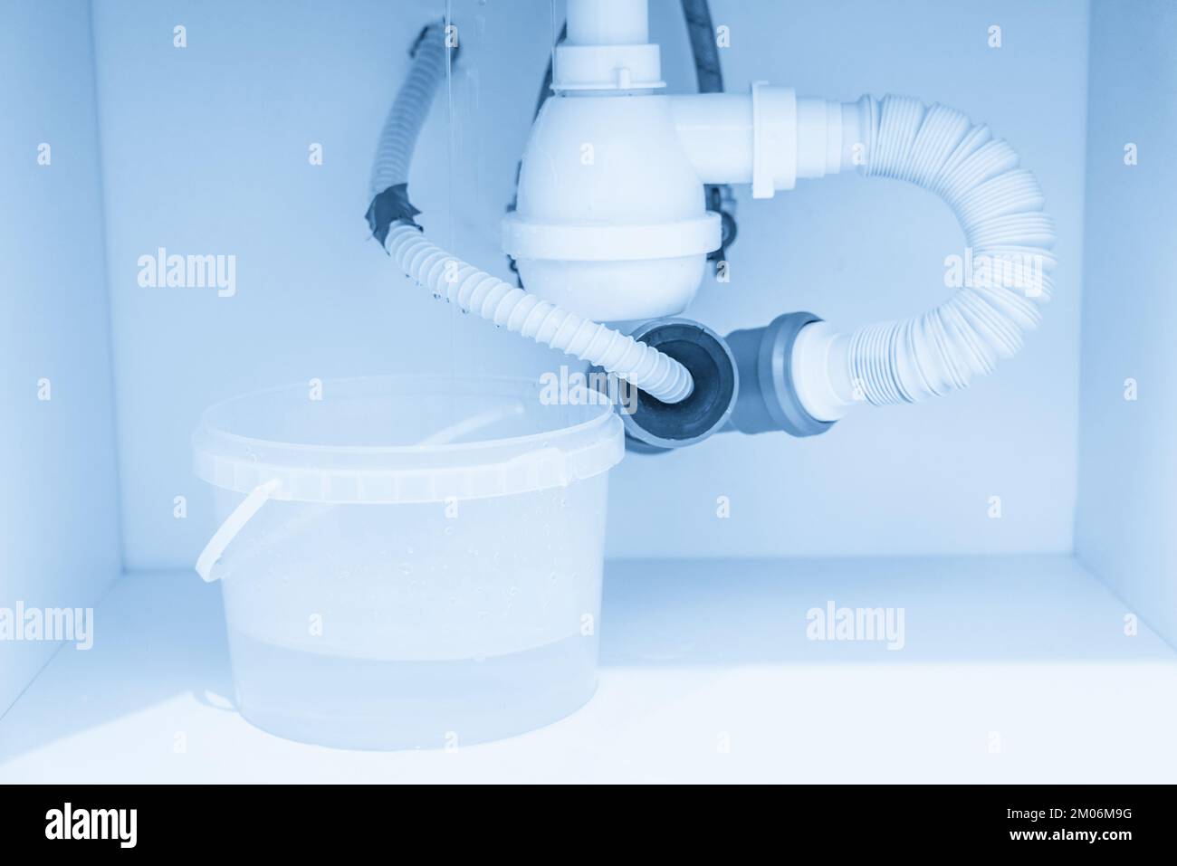 Leakage Of Water From plastic Pipe under sink in laundry room Stock