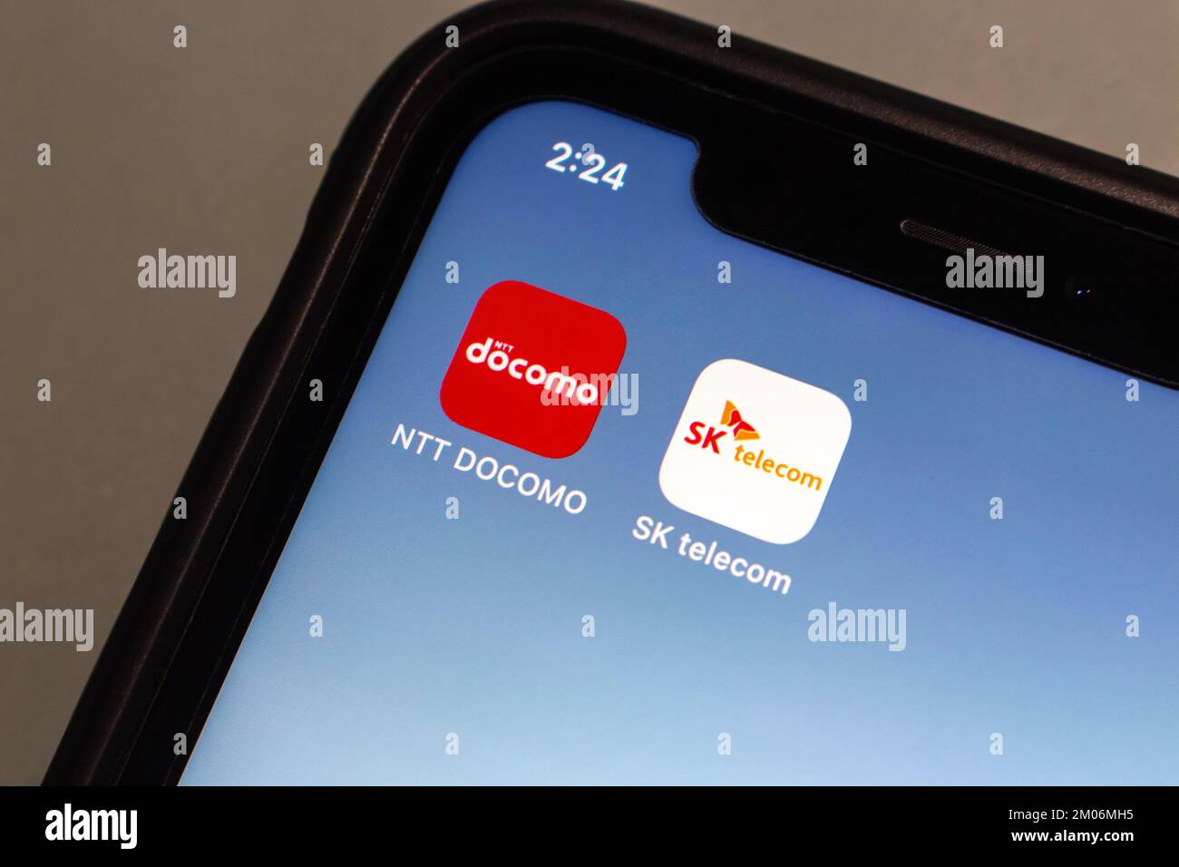 Vancouver, CANADA - Dec 3 2022 : Conceptual image NTT Docomo and SK telecom icons seen in iPhone screen. Stock Photo