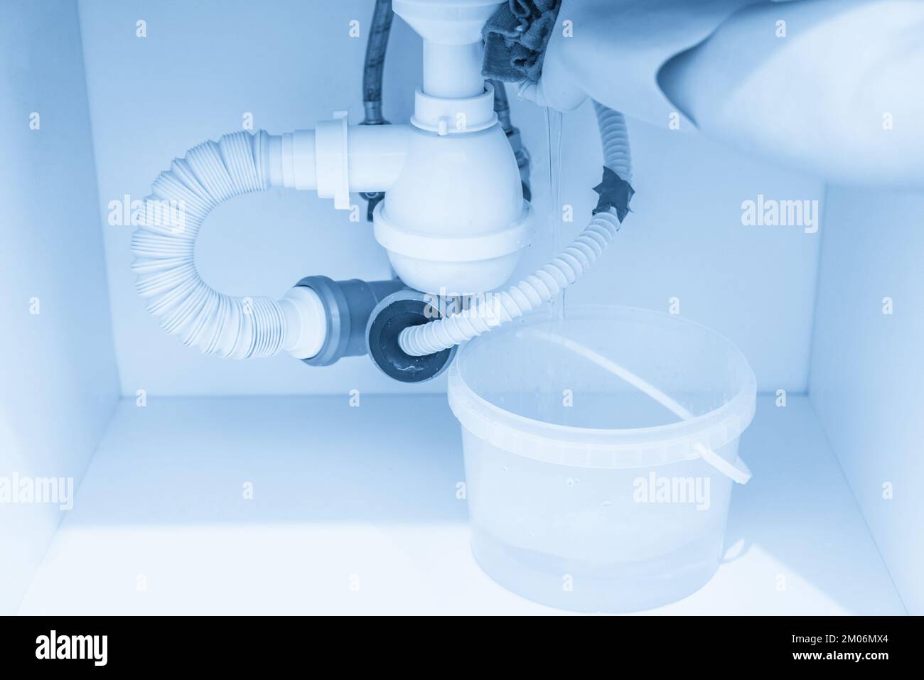 Leakage Of Water From plastic Pipe under sink in laundry room Stock