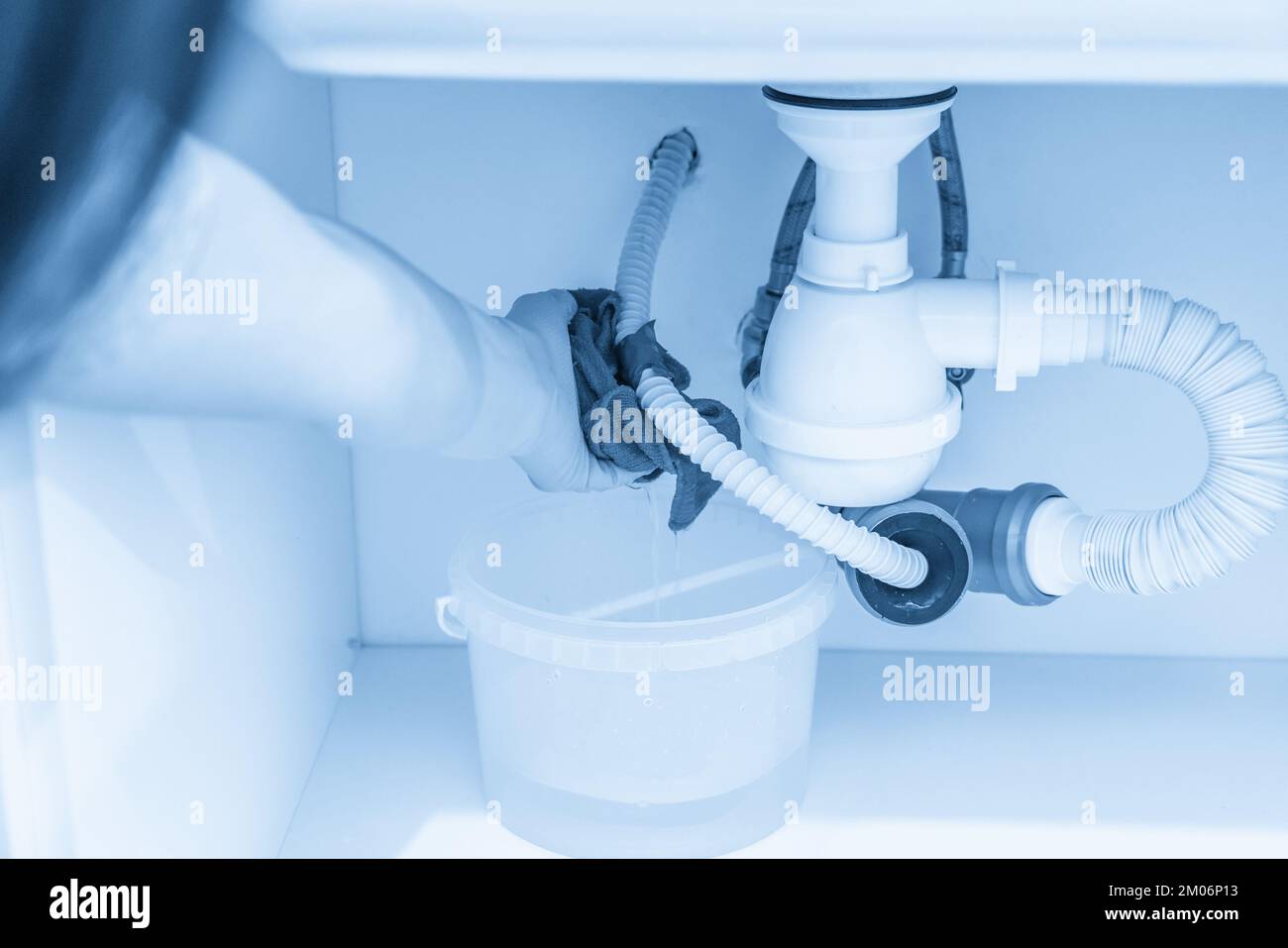 Leakage Of Water From plastic Pipe under sink in laundry room Stock