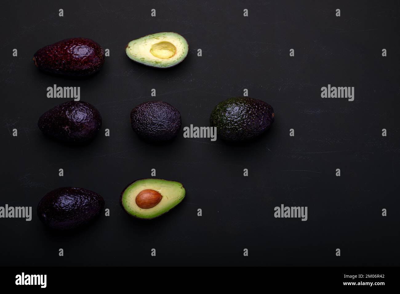 Fresh avocado on a black background. Top view. Free space for your text. Stock Photo