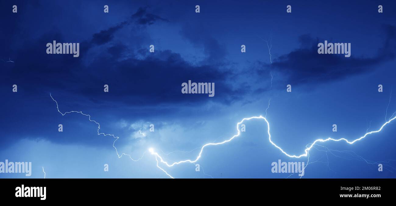 Lightning strike on a cloudy dark rainy sky Stock Photo - Alamy