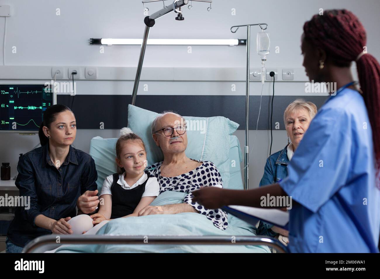 African american female nurse filling out recovery report of sick man