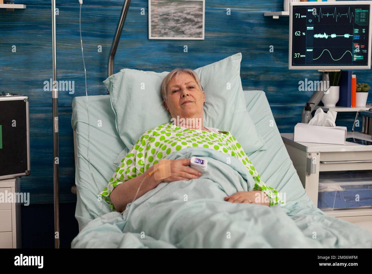 Elderly woman lying in nursing home bed receiving specialized care for