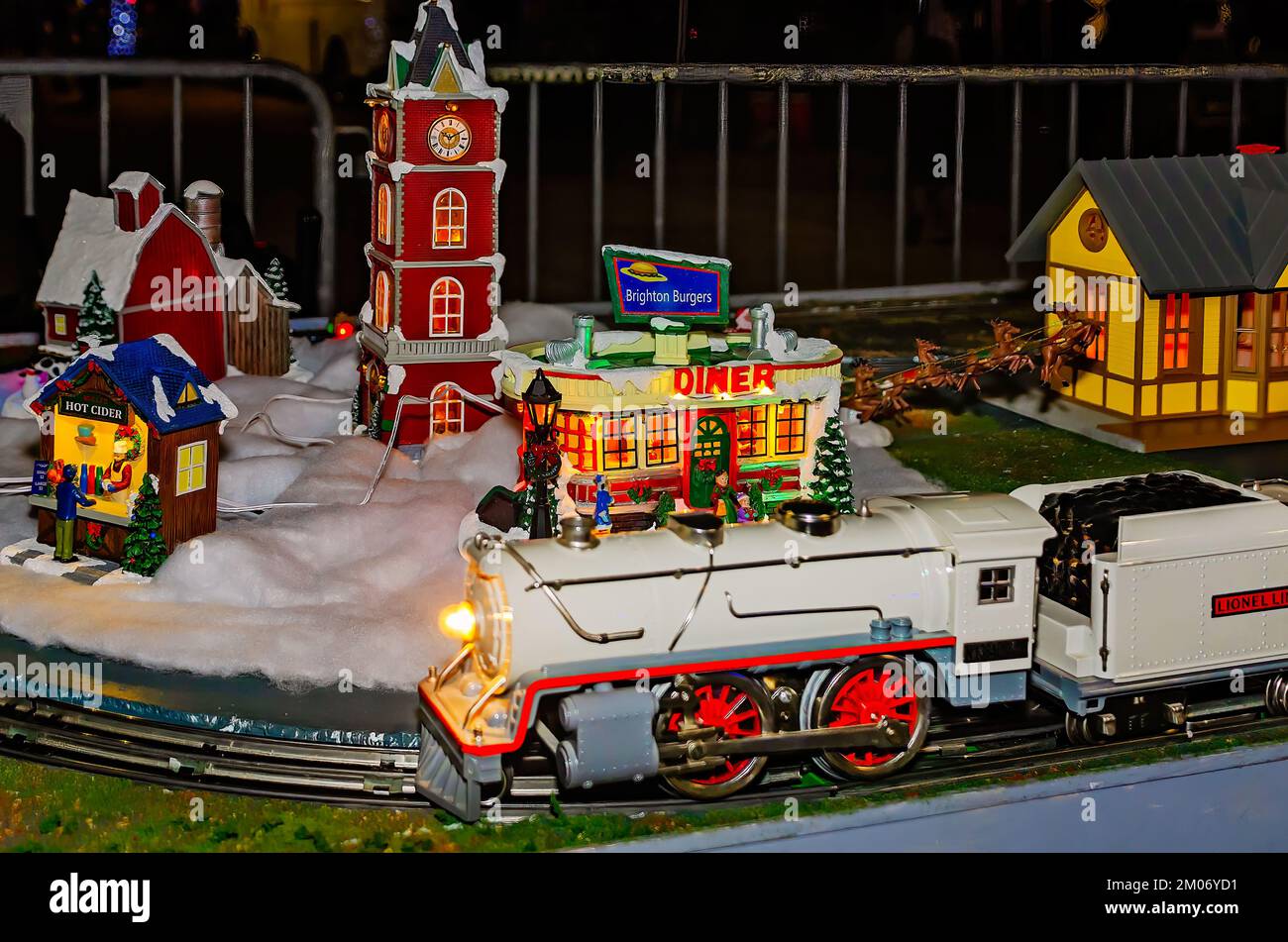 A Lionel train hauls coal past a Christmas village, Nov. 18, 2022, in Mobile, Alabama. Stock Photo