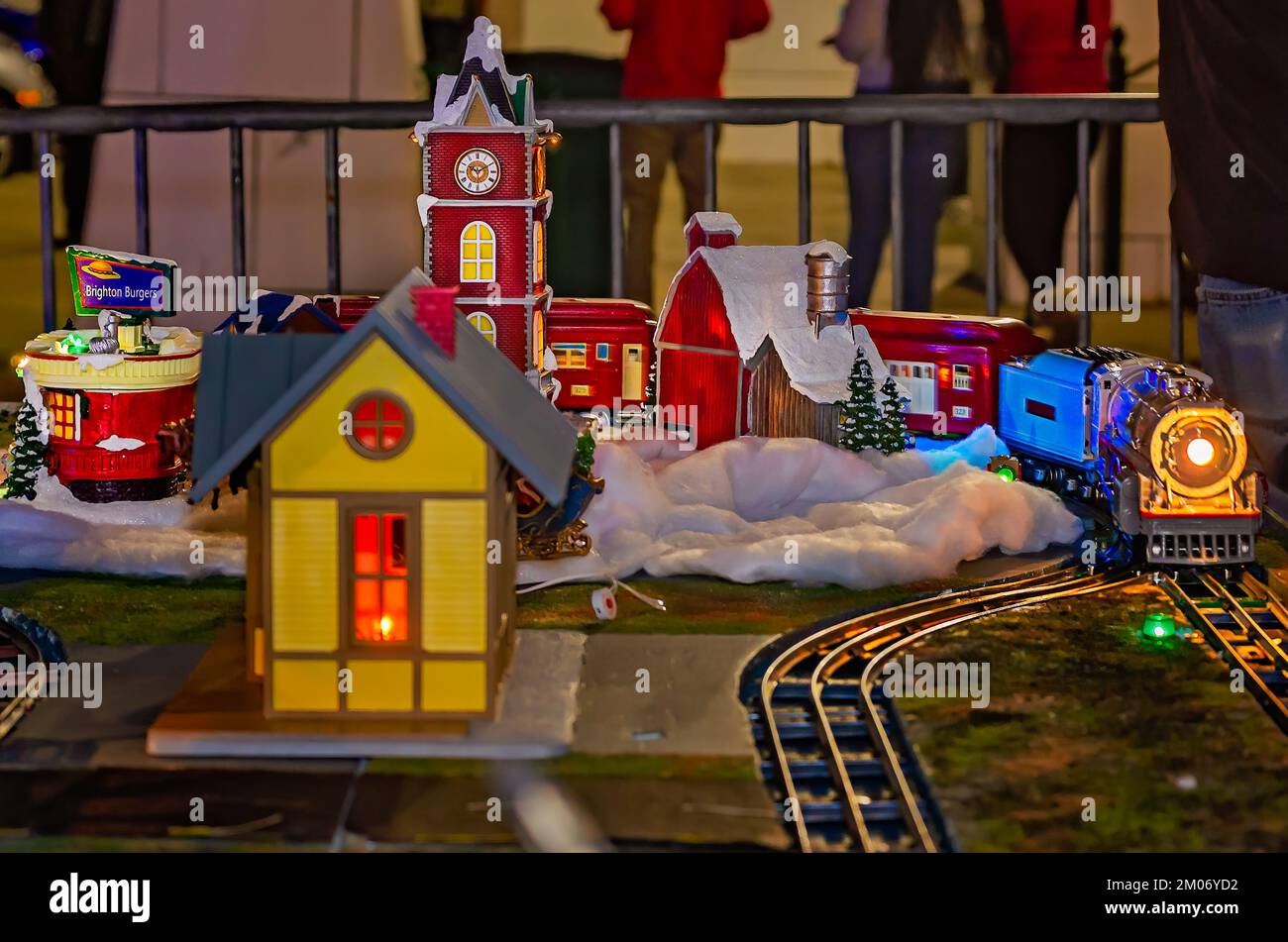 A Lionel train circles a Christmas village, Nov. 18, 2022, in Mobile, Alabama. The village was part of a model train display. Stock Photo