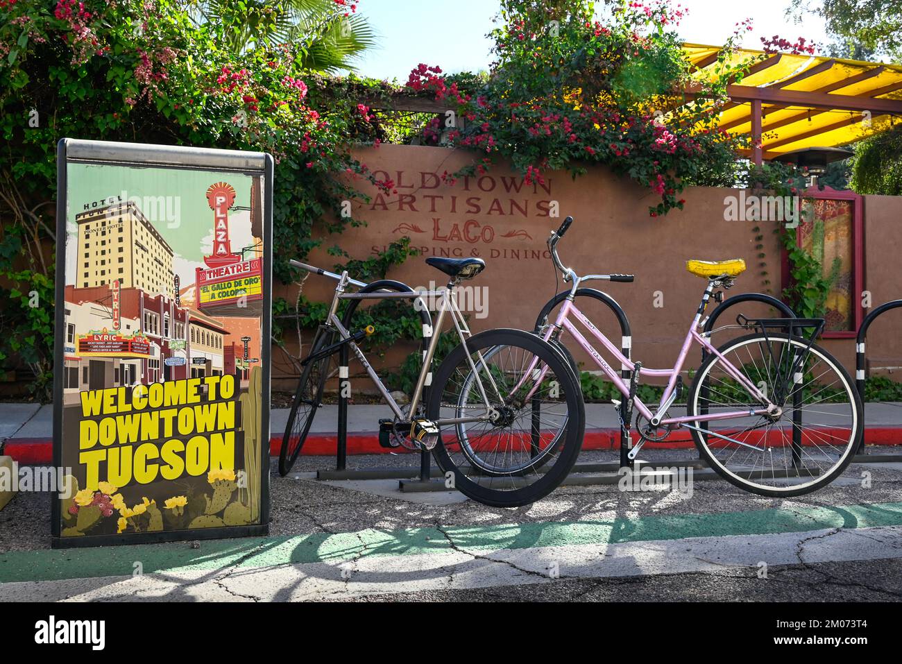 Entrance to the historic Old Town Artisans Block, located at the site of El Presidio San Augustin del Tucson, with signage and bicycles Stock Photo