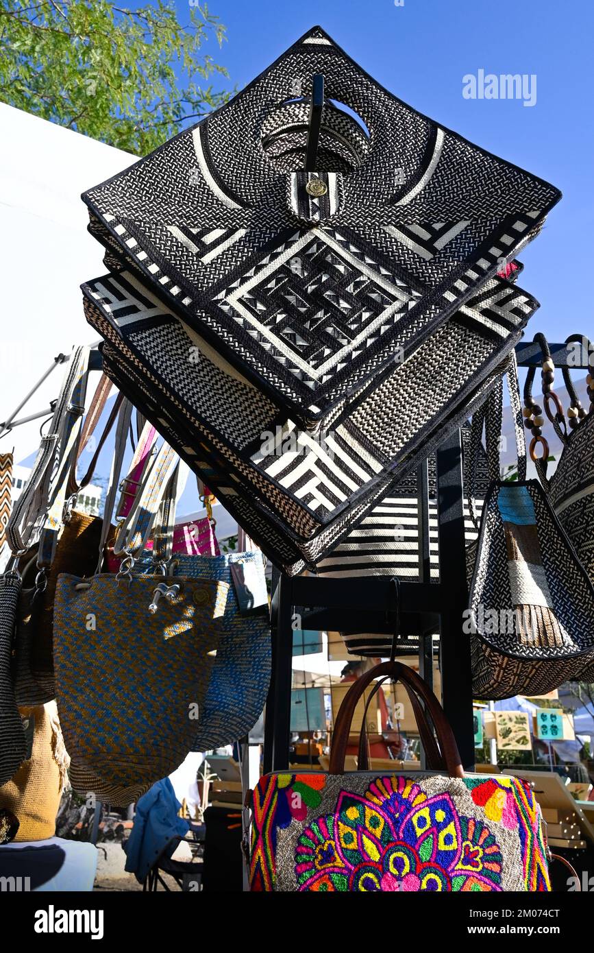 Ethnically inspired handmade bags, purses and totes with colorful woven straw and embroidery exhibited at art street fair in Tucson, AZ Stock Photo