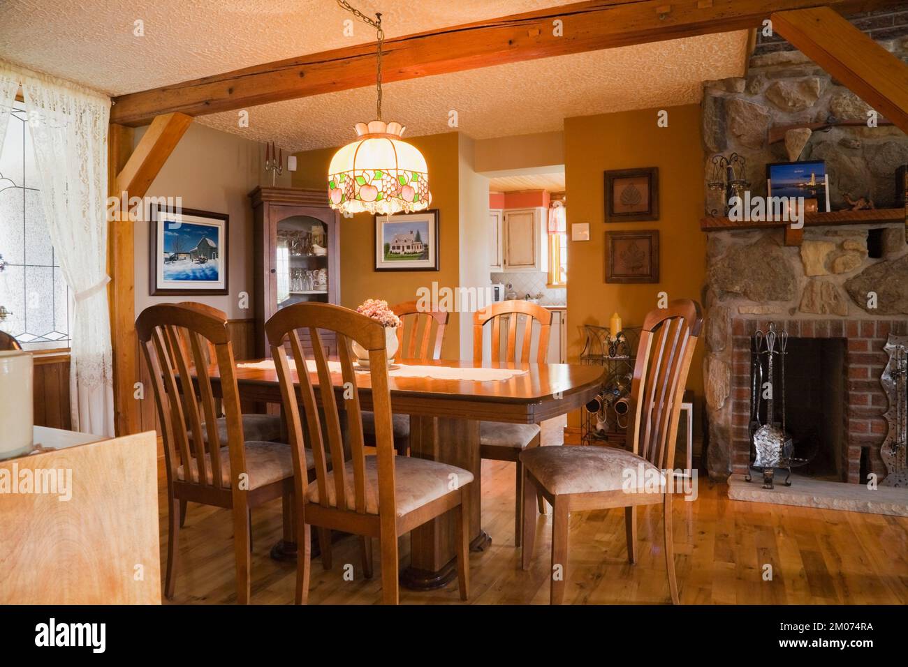 Dining table with high back upholstered chairs in dining room inside