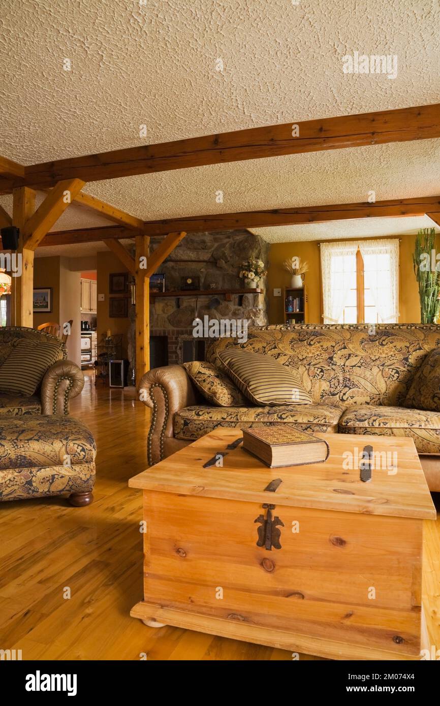 Pinewood coffee table chest and golden fabric upholstered armchair and