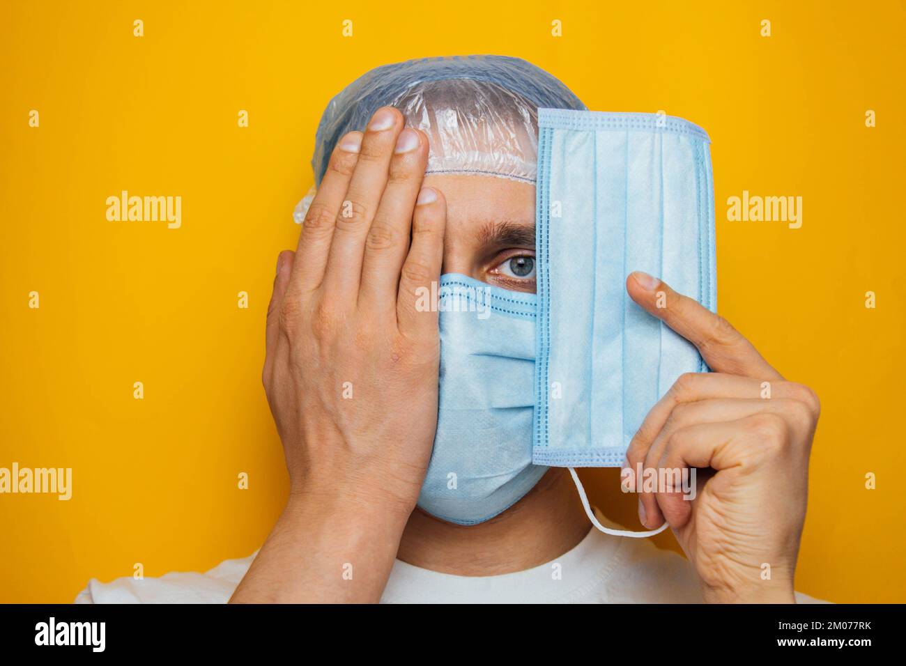 The guy puts on a respiratory mask over his eyes. Attractive man puts