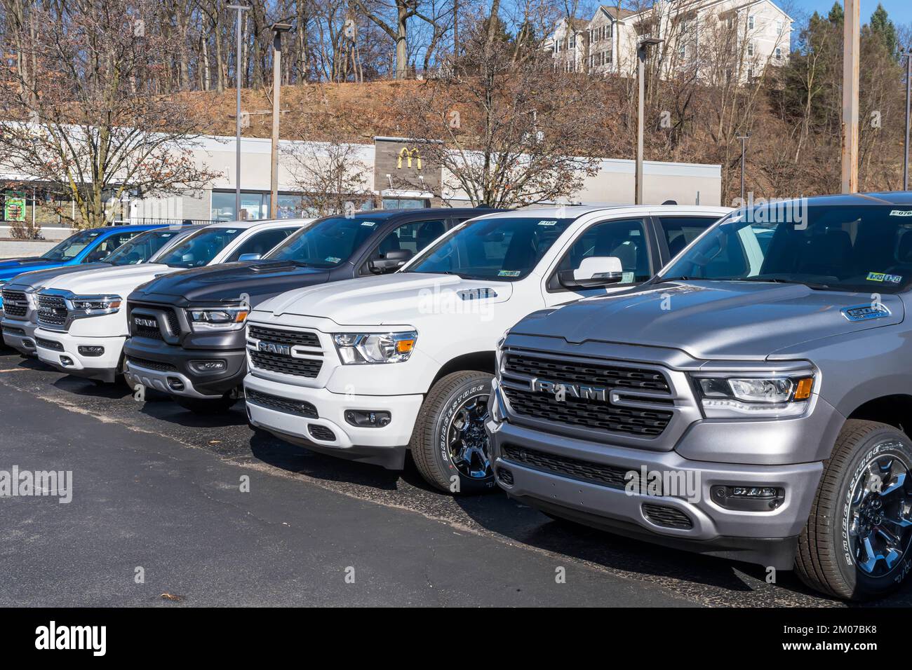 A line of new Ram trucks for sale at a dealership in Ross Township