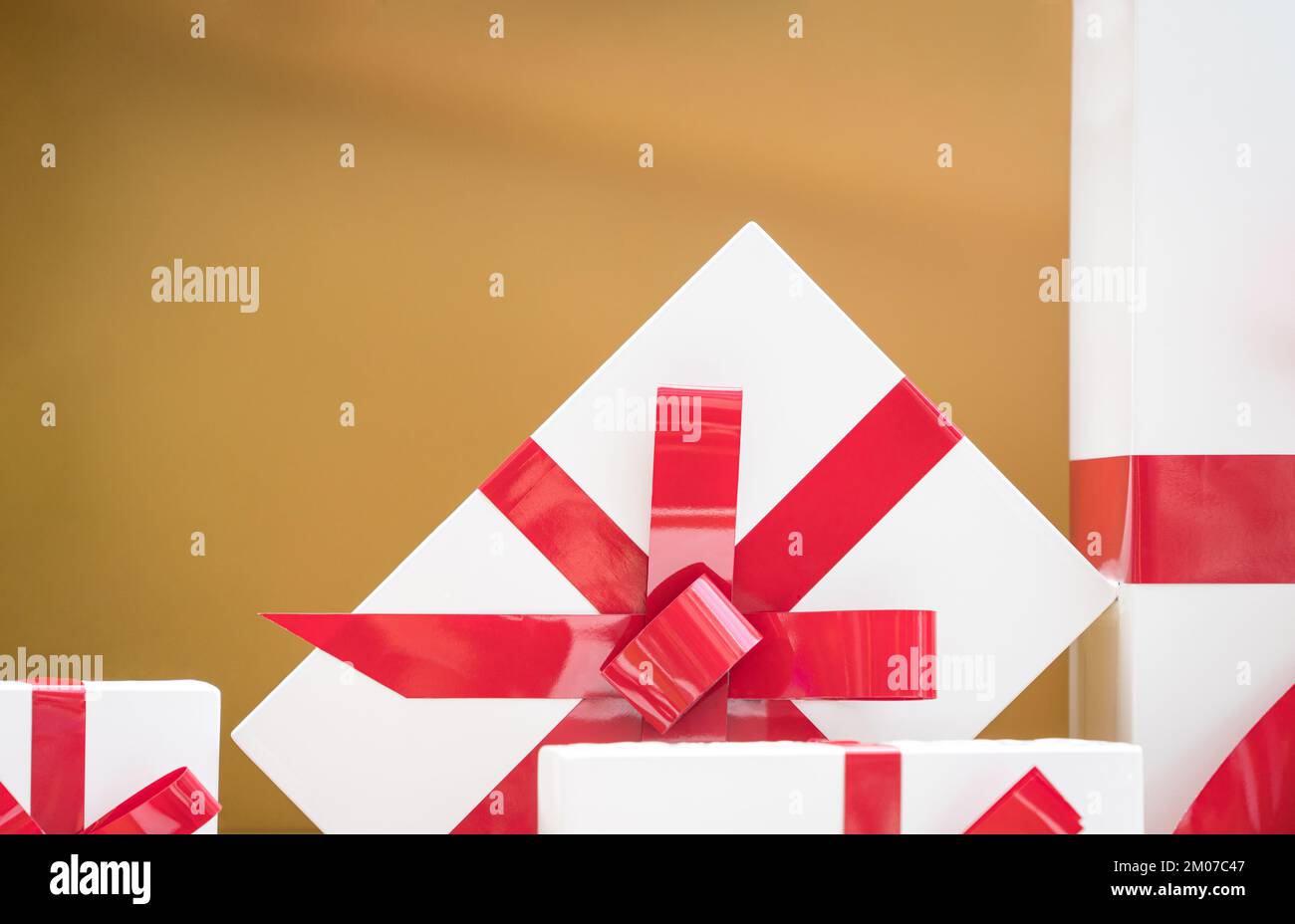 Gift boxes with red ribbons on gold background. For christmas and ...
