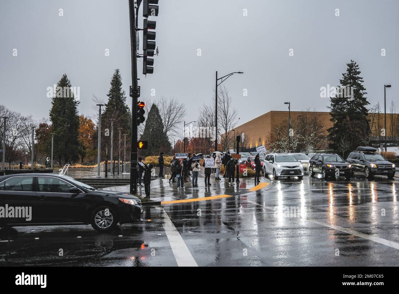 Bellevue, United States. 04th Dec, 2022. Protesters hold placards ...