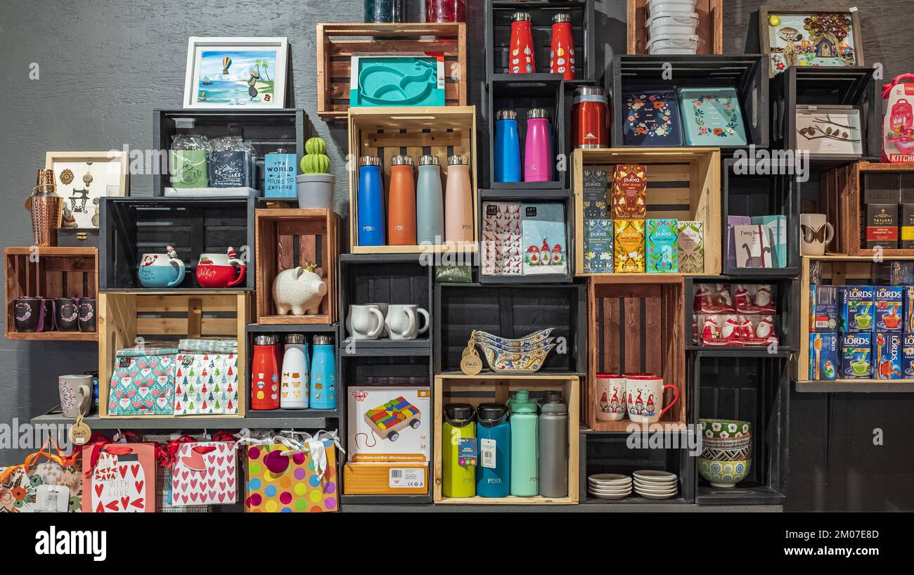 Small shop interior details. Wooden shelves with different goods and personal hygiene or cosmetics products in store. Eco-friendly shopping at local s Stock Photo