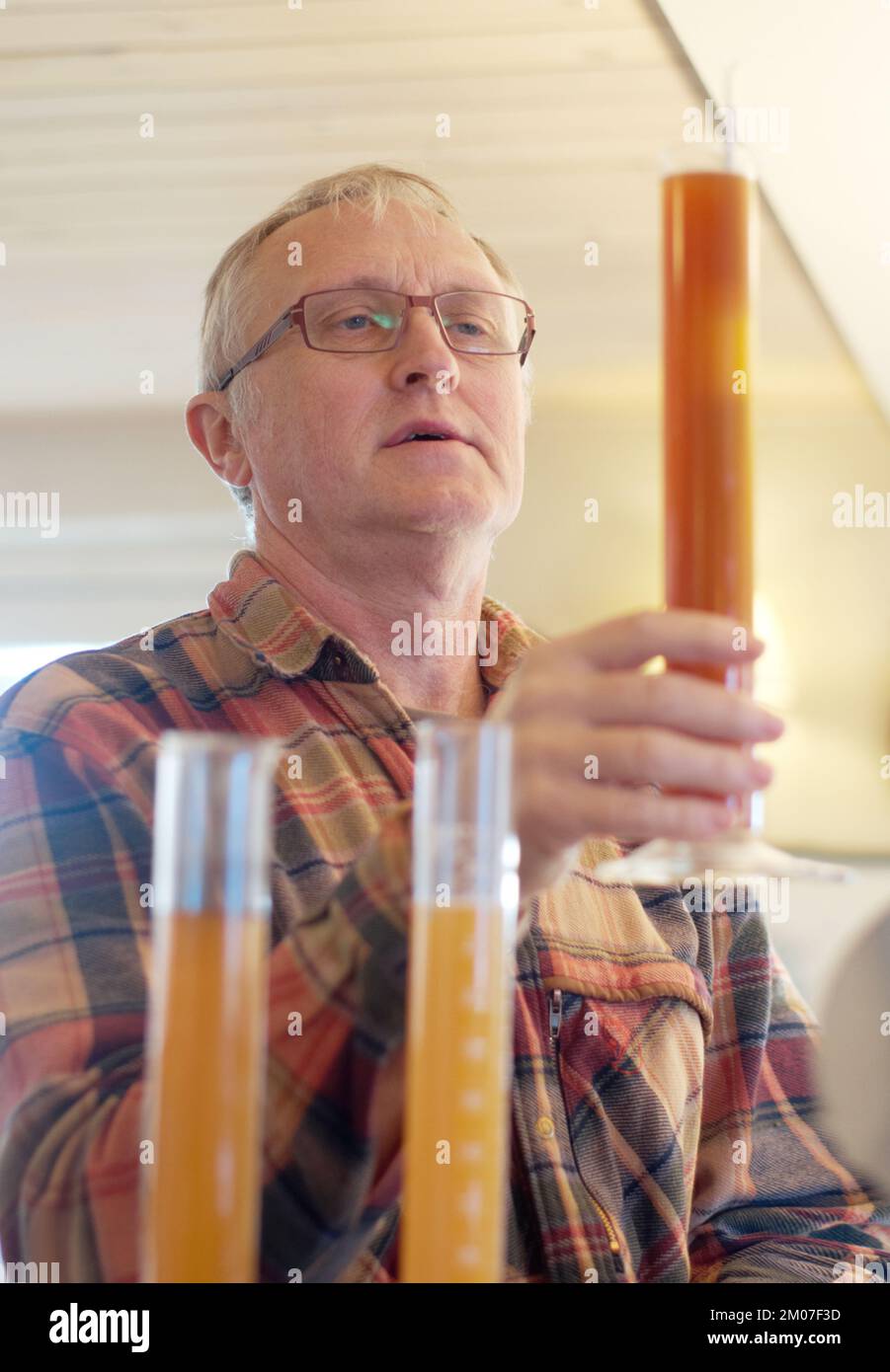 Perfection brews quality. a brewer checking the quality of his latest